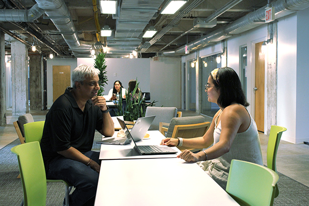 a man and a woman sitting at a tablle while talking