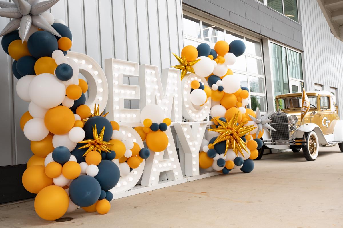 demo day big letters with a lot of baloons around them